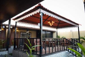 a pavilion with a table and chairs on a deck at Manish Inn Resort in Daulatābād +4 photos