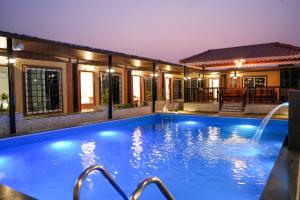 a swimming pool in a house at night at Manish Inn Resort in Daulatābād