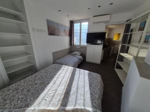 a small bedroom with a bed and a tv at Soleillas in Vence +55 photos