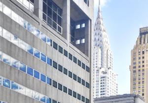 a view of the empire state building from between two buildings at Dylan Hotel NYC in New York