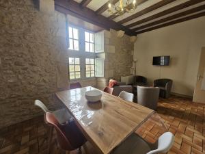a dining room with a wooden table and chairs at Château d'ayron in Ayron +11 photos
