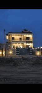 a building with lights in front of it at night at Shree Karan Palace Family Guest House in Juliāsar