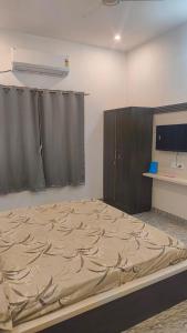 a bedroom with a large bed in a room at Shree Karan Palace Family Guest House in Juliāsar