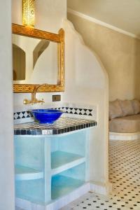a bathroom with a sink and a mirror at Hotel Sunset Palace in Merzouga +125 photos