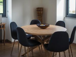 a wooden table with chairs and a bowl on top at 12 Casa d'Avó in Albergaria-a-Velha