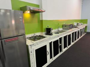 a kitchen with green and white counters and appliances at Chateau Nougat, Marrakech in Marrakesh