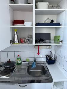 a kitchen with a sink and a counter top at Kumpukuja apartment in Kouvola +6 photos