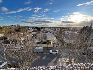 a view of a city with cars parked in a parking lot at Hotel Portofino in Empuriabrava