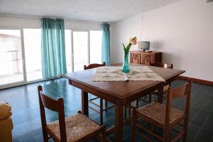a dining room table with a vase of flowers on it at La Mansarda Navarrese in Santa Maria Navarrese