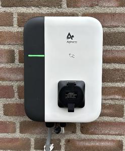 a black and white soap dispenser on a brick wall at Domaine de Vauvelle in Maux