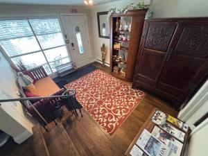 an aerial view of a living room with a red rug at Vintage Pines Guest House in Niagara-on-the-Lake