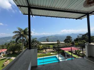 a view from the balcony of a house with a swimming pool at Finca Campestre Colibrí in Quebradanegra