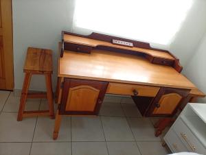 a wooden desk in a room with a stool at GRACE self-catering apartments in Goodwood