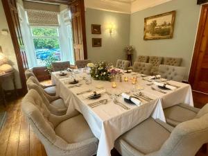 a dining room with a long table and chairs at The Grasmere Hotel in Grasmere +17 photos