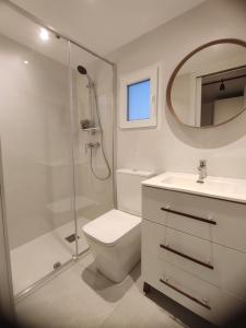 a bathroom with a shower and a toilet and a sink at Apartamento in Arona +4 photos
