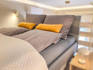 a couch with two pillows on it in a room at Frida Loft in Pécs