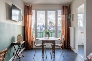 a table and chairs in a room with a window at La Cabane Parking privatif et Balcon in La Riche +23 photos