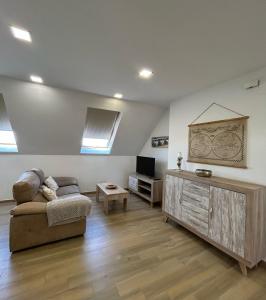 a living room with a couch and a tv at Edificio Type I in Puente Genil