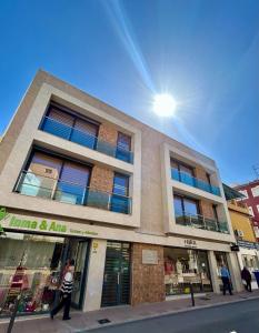 a man walking in front of a building at Edificio Type I in Puente Genil