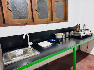 a kitchen counter with a sink and a stove at Nihal Villa in Weligama