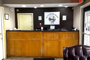 a bar in a waiting room with a leather chair at Woodbridge Inn By OYO Rome in Rome