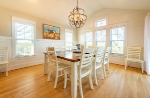 a dining room with a table and chairs at Sea Fever - Duck, Saltaire, 130 Yds to Beach, Ocean View, Pool, Hot Tub, Tiki Bar, Flex Stays in Duck +49 photos