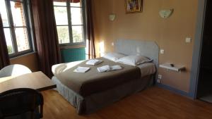 a bedroom with a bed with two towels on it at L'Hôtel de la Taverne in Étretat