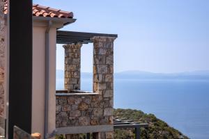 a view of the ocean from the balcony of a house at Searocks Exclusive Village in Kalamata