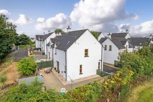 an overhead view of a row of white houses at Cappaghmore by Escape Ordinary in Portstewart