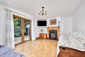 a living room with a couch and a fireplace at Cappaghmore by Escape Ordinary in Portstewart