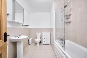 a bathroom with a sink and a toilet and a shower at Cappaghmore by Escape Ordinary in Portstewart +17 photos