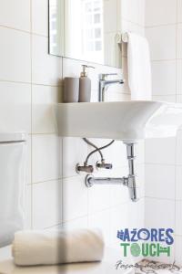 a bathroom with a sink and a mirror at Hostel Casa São Pedro in Angra do Heroísmo