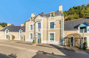 a large house with a gate in front of it at Bord De L'Eau 3 et 6 in Cancale