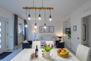 a living room with a table with a bowl of fruit at LAKE COMO BORGO VIGNOLA - Cozy Apartment in a Charming Village in Cremia +88 photos