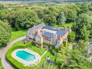 an aerial view of a large house with a swimming pool at Daisy Cottage in Polegate