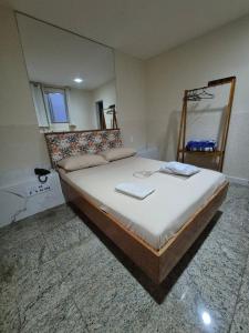 a bedroom with a large bed with a mirror at Hotel Casa Blanca - Adults Only in Rio de Janeiro