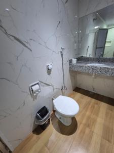 a bathroom with a white toilet and a sink at Hotel Casa Blanca - Adults Only in Rio de Janeiro +26 photos