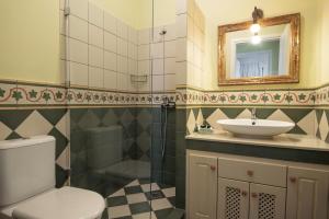 a bathroom with a toilet and a sink and a mirror at Sky & Sea View Retreat in Telendos +28 photos