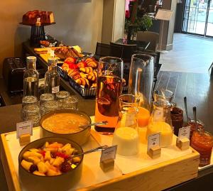 a buffet of food and drinks on a table at Hotel Sixteen Paris Montrouge in Montrouge +41 photos