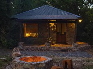 a house with a fire pit in front of it at EntreViñas in Carmelo
