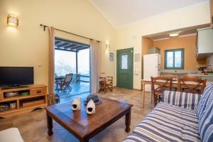 a living room with a couch and a table at Sky & Sea View Retreat in Telendos