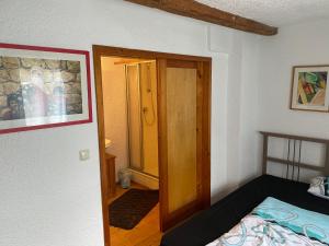a bedroom with a bed and an open door at Schöne Tage im Denkmal in Bittstädt