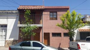 a building with a car parked in front of it at Apart Salta in Salta