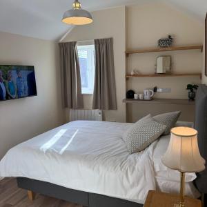 a bedroom with a white bed and a window at Town Centre - 22 Billet Street in Taunton
