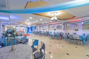 a banquet hall with blue tables and chairs at Hotel Presidente Internacional in Guayaquil