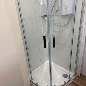 a shower with a glass door in a bathroom at Town Centre - 22 Billet Street in Taunton