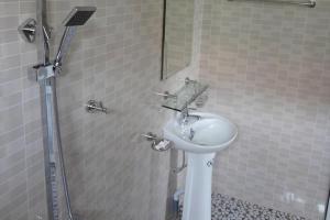a bathroom with a sink and a shower at Paradise Hotel in Phong Nha +45 photos