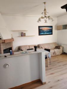a living room with a table and a couch at B&B 3B Cavriana in San Valentino