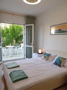 a bedroom with a bed with two green towels on it at Orebic BnB in Orebić