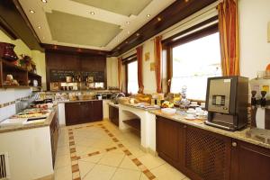 a large kitchen with wooden cabinets and a counter top at B&B Kaiserstube in Flachau
